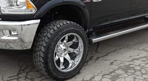 Close-up of the tread and tire on a black pickup outside Belt Alignment