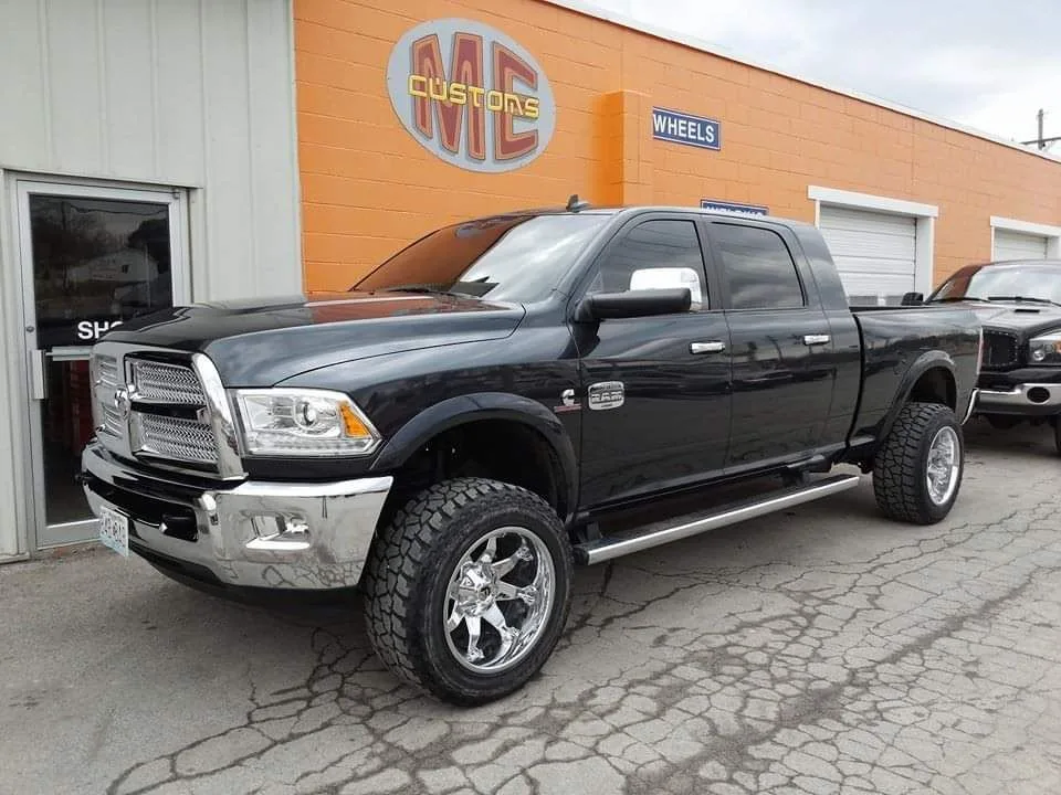 A black pickup outside the orange shop